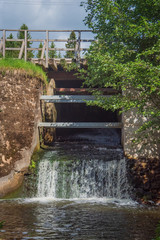 Closeup of mill waterfall at on sunny summer day