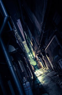 Alley Amidst Buildings At Night