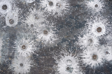 white splatters of lead spalling from a 45 pistol on a target - obrazy, fototapety, plakaty