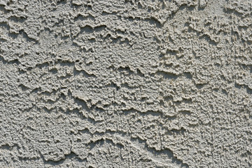 textured background of concrete or stucco in bright sunlight