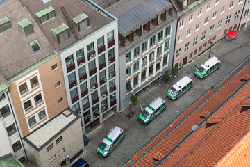 Munich aerial top view on the city street from above in old town with buildings, street and police cars in row  © Irina
