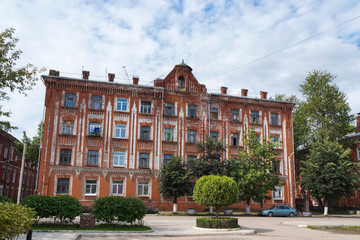 Facade of an old red brick house in art Nouveau style, late 19th century. One of the buildings in the historical architectural and industrial complex "Morozovsky quarter", Tver, Russia