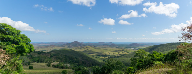 Fototapeta na wymiar panorama of new Caledonia. sky is blue with white clouds. hill and sea in the background.