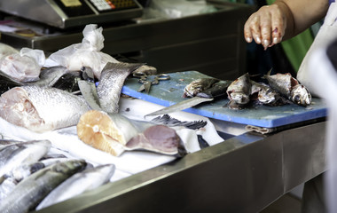 Woman cutting fish