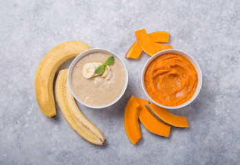 Bowls with healthy baby food on color background. Purees, made of fresh organic fruit and vegetables, flay lay, top view, concept. Kids meal
