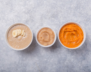 Bowls with healthy baby food on color background. Purees, made of fresh organic fruit and vegetables, flay lay, top view, concept. Kids meal