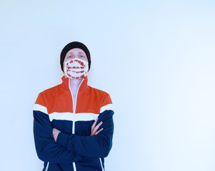 Young man in a sports jacket with a medical mask