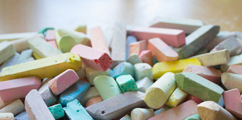 A bunch of colorful pieces of chalk close-up space to copy. Concept: children's creativity