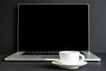White coffee Cup on laptop front view copy space.The trend: monochrome