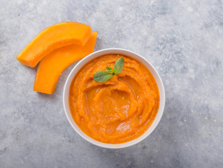 Bowls with healthy baby food on color background. Purees, made of fresh organic pumpkin flay lay, top view, concept. Kids meal