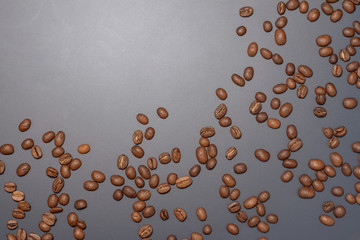 Composition with random coffee beans from corner to corner on isolated dark background with place for caption