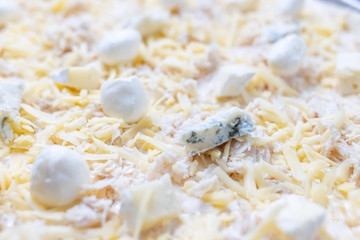 Close up image of cheese pizza ready for baking