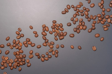 Line of random coffee beans from corner to corner on isolated dark background
