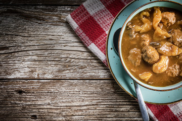 Meatballs in gravy with cast noodles.
