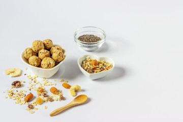 Healthy homemade energy balls with nuts, oats, dried fruit, chia seeds. Vegetarian raw organic food.  Horizontal orientation. Copy space for text