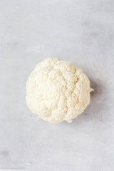 Fototapeta na wymiar Cauliflower on grey background, fresh vegetable for catalog products, vertical format. Healthy content.