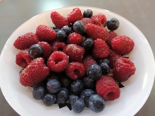 Raspberries and currants in a bowl. Dessert salad 
