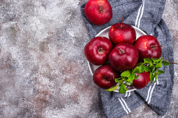Fresh red ripe apples on gray background