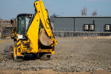 Yellow wheel loader Excavator machine working at construction site with a sand and gravel....