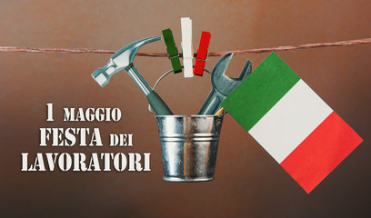 1 May Workers labor day text in italian. italy flag, hammer and wrench - grunge abstract image