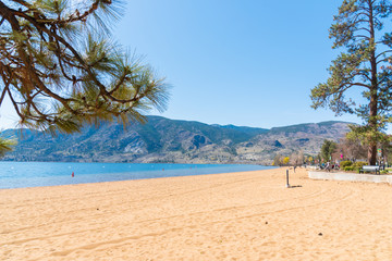 View of the large sandy beach at Skaha Lake in Penticton, BC, Canada