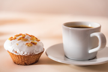 Dessert coffee with Muffin on light table. Close up.