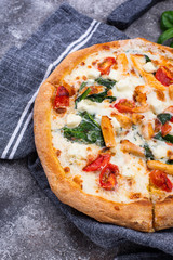 Italian pizza with tomato, mozzarella and chicken