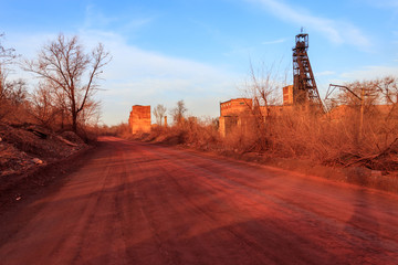 Fototapeta premium Red dirt road polluted with iron ore near iron ore quarry in Kryvyi Rih, Ukraine