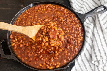 Bourbon Baked Beans in a Cast Iron Skillet: Pork and beans seasoned with bourbon whiskey, molasses,...