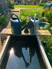 Watering cans left on an allotment plot in London