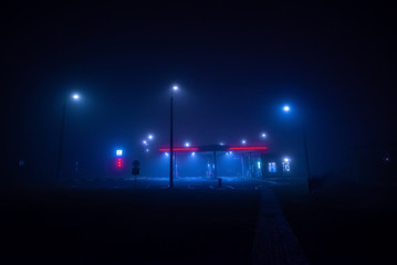 Night gas station in the fog