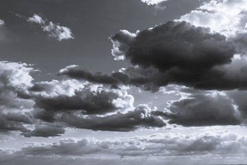 Obraz premium Scenic cloudy sky in black and white. Sunlight in high large dramatic cloudscape moody greyscale background
