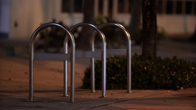 Night static shot of a city bike rack stainless steel or aluminum