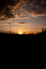 
sunset in prague near train tracks. Street lamps are visible
