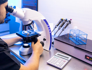 Man Technician working with laboratory equipment