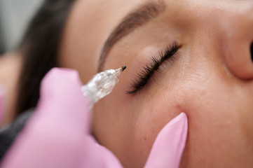 Female permanent eyeliner tattoos enhancement coloring in spa