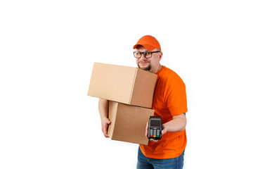 Friendly young man from a courier delivery service holds big boxes in his hands and a terminal for cashless payment on a white background