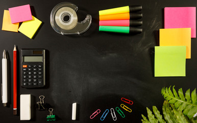school stationary supplies on black chalkboard background with copy space ready for graphic design, school education learning concept