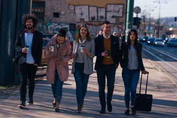 Obraz premium Group of friends (colleagues) hanging out in an urban area.