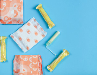 
blue background, three female pads and four tampons.
