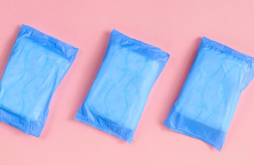 Blue and pink. Panty liners on a pink background along the diagonal.