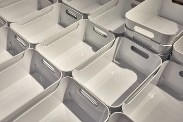 Plain plastic bin boxes for home organization sold in a pile