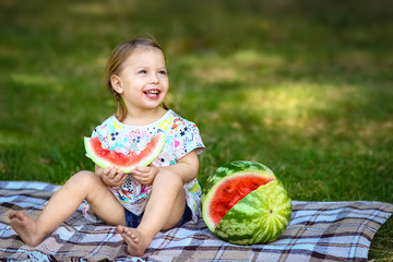 Fototapeta premium happy child with watermelon on nature in the park