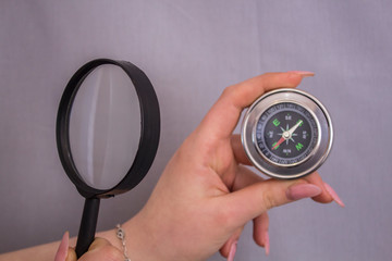 looking through a magnifying glass at a compass