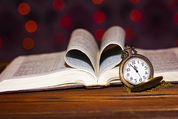 a pocket watch with book background