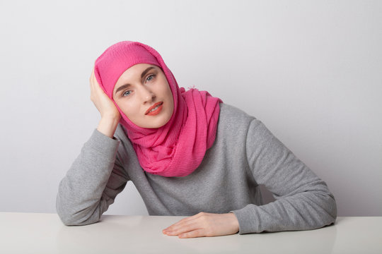 Close-up portrait of a muslim woman wearing a head scarf hijab and smilling. Isolated.