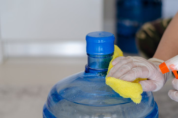 The woman disinfects the carboy