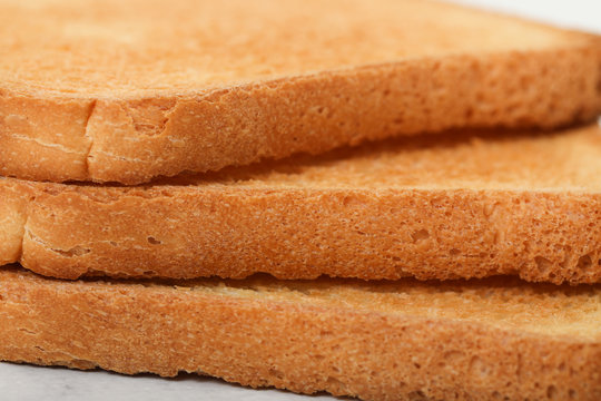 Toast biscuits over white background crunchy food
