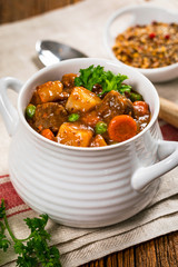 Beef Stew with Potatoes and Carrots made in a Slow Cooker. Selective focus.