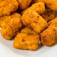 Crispy Fish Bites Snack Size. Deep Fried Pollock Fish Fingers with Tartar Dipping Sauce on a Wooden Board. Selective focus.